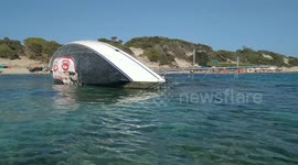 Shipwrecked yacht winds up on Ibiza beach with ecology message