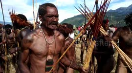 Ethnic tribesmen in Indonesia sing and dance in festival celebrating culture