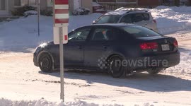 Cars sliding and crashing on snow and ice covered slippery street on a cold winter day