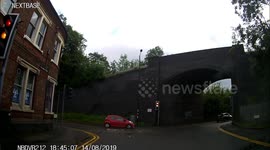 Car runs red light then near miss