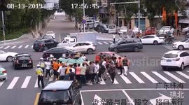 Passersby join forces to rescue people trapped beneath taxi