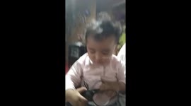 1-year-old girl crying is prohibited from eating cell phone chargers