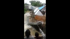 Dramatic moment shops on river edge collapse and get washed away in central Indian floods