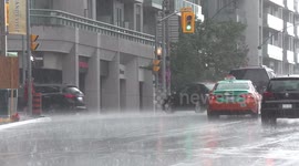 Torrential rain in severe thunderstorms has people running for cover in Toronto downtown area