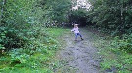 Little girl slips and falls on hill.