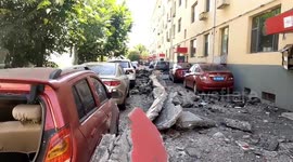Building's roof collapses in China's Xinzhou and narrowly misses woman