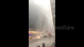 'It looks like somebody is power washing the sidewalks' Rain lashes New York streets