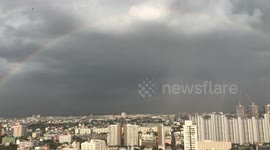 Full rainbow over Bangkok before thunderstorm