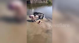 Heroic men rescue people trapped in car that landed upside down in a river in China