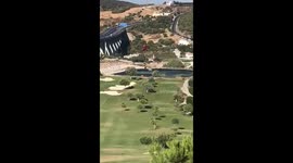 Wildfire Spain Fire Fighting Helicopter fills up at Golf course Lake