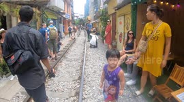 Tourists warned as they set up cafes inches from speeding train dubbed 'death rails'