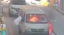 Minibus driver escapes through window after vehicle catches fire at petrol station in China