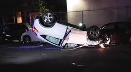 Hatchback Rolls on It's Roof Possibly After Crashing Into Parked Cars