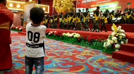 Small child mimics moves of Indonesian army cadets during inauguration
