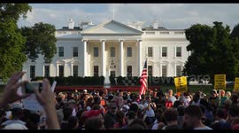 Protesters Outside The White House Hold Signs