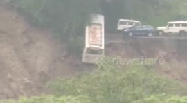 Heartstopping moment parked vehicles fall off cliff as landslide wreaks havoc in northern India