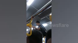Bus conductor in the Philippines dubbed 'Spider-man' as he climbs over passengers' heads to collect fares