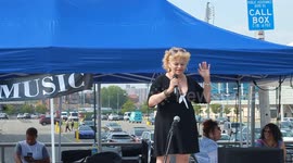 woman singing on boardwalk