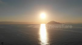 Mediterranean sunrise with yacht.