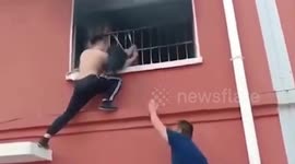 Heroic man tears down windows to rescue teen trapped in burning flat in China