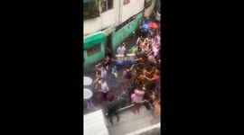 Carnival in Philippines crosses road flooded by Storm Bailu