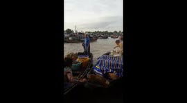 The women were on small boats processing food for tourists on the river