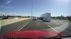 Sport bike speeding past stopped traffic on the hard shoulder.