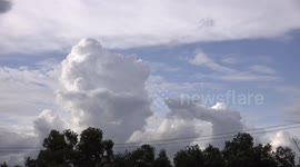 A face in the clouds, looking up into the sky, it seems to have Donald Trump's hairstyle?