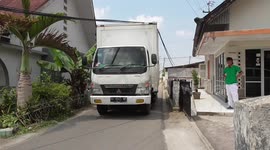 Bread truck fails to clear telephone lines and blocks traffic in Indonesia
