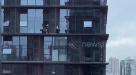 Heroic policemen rescue distressed woman from window ledge