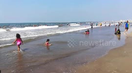 Girls Play On Ras El Bar Beach Blue Water