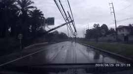 Terrifying moment electricity pylons are blown onto car during Thai storm