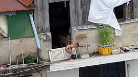 Shocking moment toddler walks along concrete ledge four storeys off the ground