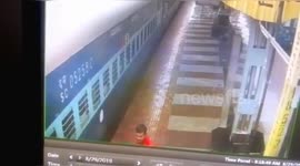 Miraculously survies a man as Indian cop rescued him from the gap as he fell from the  train in southern India.
