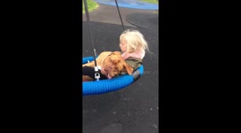 Violet can’t get enough of the swing with her big sister