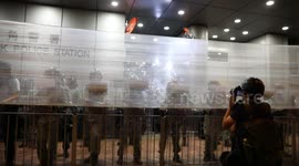 Hong Kong police take cover behind netting and riot shields