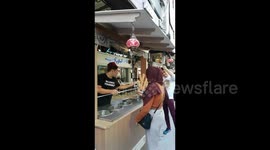Malaysian vendor continuously tricks customer into grabbing ice cream cone