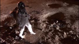 Indian artist pokes fun at potholes by dressing as an astronaut and 'moonwalking'