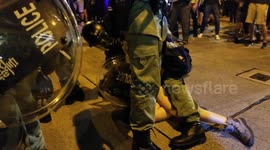 Young woman forcefully detained after intense skirmish outside Hong Kong police station