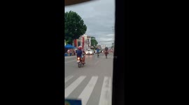 Man In Motorcycle Helmet Rides Horse Along Road