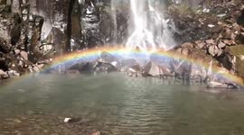 Mist from Brazil waterfall creates miniature rainbow