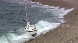 Yacht runs aground on beach in Portland on England's south coast