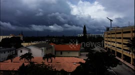 Dark clouds and strong winds slam palm trees ahead of Hurricane Dorian's arrival in Florida