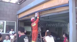 Firefighters in China rescue boy who got his head trapped in garage's roller shutter
