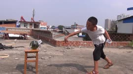 Chinese boy shows off incredible skills by flinging playing cards into fruit