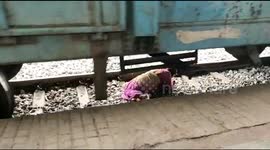 Elderly woman miraculously escapes after falling under train in south India