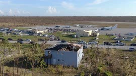 Treasure Cay Airport in Abaco Aerial view of devastation as crowd of survivors are evacuated out by plane