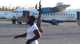 Injured old man assisted to evacuation airplane at Treasure Cay Airport Abaco after Hurricane Dorian