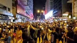 Hong Kong Protesters singing protest songs on a main road outside Mong Kok Police Station