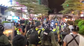 Hong Kong Police are attacked with bricks as they retreat back to their recreation club in Mong Kok